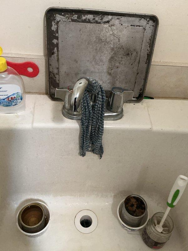 Completed routine plumbing membership inspection of facility restroom and utility areas. Evaluated condition of utility sink with wall-mounted faucet assembly, noting significant deterioration of access panel requiring future attention due to extensive rust and corrosion. Inspected toilet fixture, supply line connections, and flush mechanism, confirming proper operation and no active leaks.