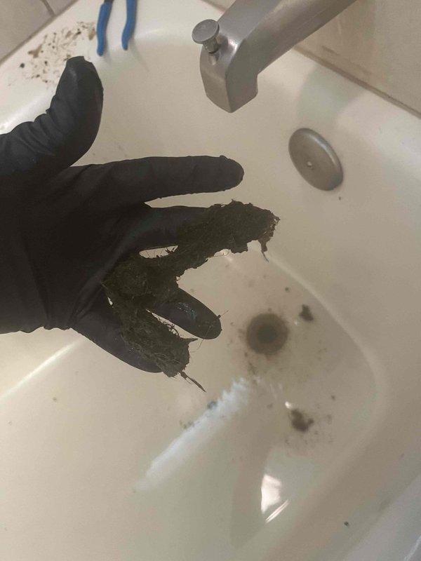 Responded to callback for recurring toilet drainage issue. Upon inspection, discovered significant blockage in drain line with accumulated debris and sediment buildup. Removed obstruction material from plumbing system and performed soldering work on brass fittings and connections beneath fixture to address underlying drainage problem. Cleared drain line and verified proper flow restoration.