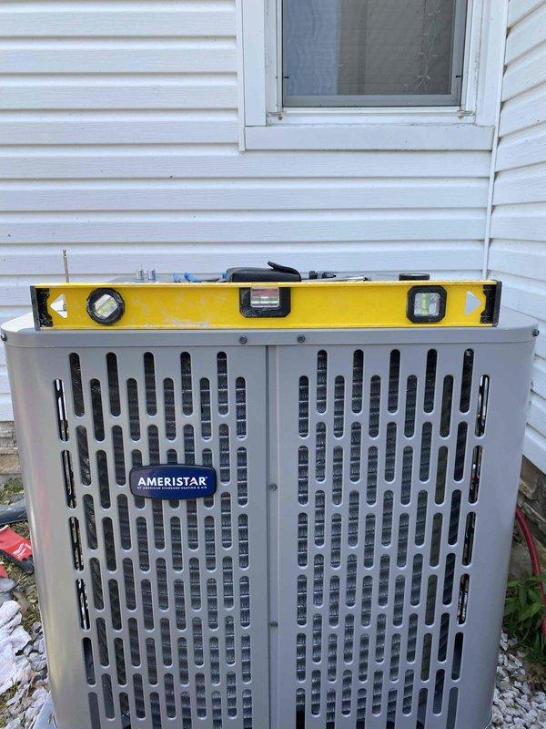 Completed installation of new Ameristar air conditioning system at residential property. Unit was properly leveled, refrigerant service valves installed with gauges, and copper line set connections completed with appropriate insulation. System installed on gravel pad against exterior wall per manufacturer specifications and all connections verified for proper operation.