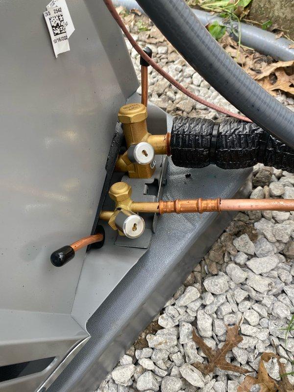 Completed installation of new Ameristar air conditioning system at residential property. Unit was properly leveled, refrigerant service valves installed with gauges, and copper line set connections completed with appropriate insulation. System installed on gravel pad against exterior wall per manufacturer specifications and all connections verified for proper operation.