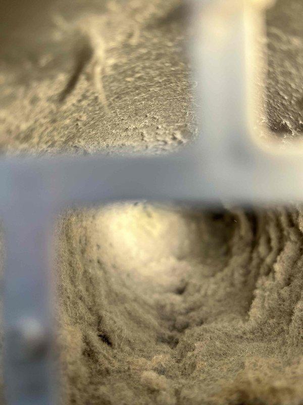 Responded to report of leaky ceiling in four-year-old residential property. Upon investigation, discovered the water intrusion was not plumbing-related but originated from HVAC system components. Inspected ductwork and ventilation system in affected area and found extensive accumulation of dust, lint, and debris throughout the duct interior and surrounding metal framework. The buildup was severe enough to potentially restrict airflow and cause condensation issues that could lead to moisture problems and ceiling damage. Documented conditions with photographic evidence showing thick, matted dust coating on metal surfaces and circular duct openings with crystalline-like debris accumulation along interior walls. Advised homeowner that the leak source requires HVAC specialist attention for proper duct cleaning, system inspection, and resolution of moisture issues rather than plumbing repair.