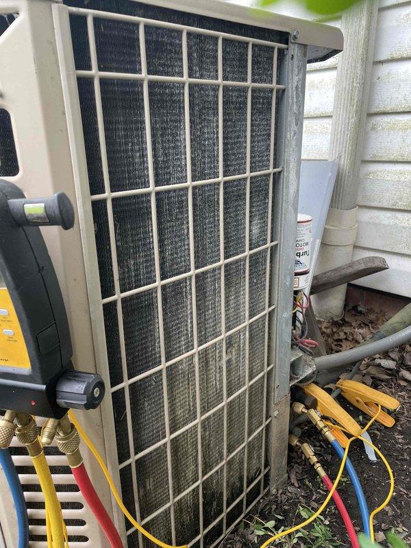 Responded to no cooling call on York air conditioning unit over 10 years old. Upon arrival, connected manifold gauges to assess system pressures and found unit not operating efficiently. Inspected outdoor condenser unit and observed heavily soiled condenser coil with significant accumulation of dirt, dust, and debris restricting airflow through the fins. Performed thorough cleaning and maintenance of the condenser coil to restore proper heat transfer and system operation.