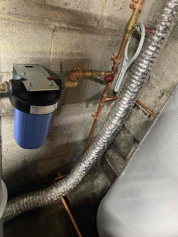 Responded to no water complaint at residential property with well water system. Upon arrival, conducted systematic diagnostic of water supply components including well pump, pressure tank, and distribution system. Inspection revealed Flexlite pressure tank with compromised air charge, preventing proper pressure cycling and water delivery to fixtures throughout home. 

Tested pressure switch operation and verified electrical supply to well pump was functioning correctly. Measured tank pressure at bladder valve and found insufficient air pressure to maintain proper water-to-air ratio within pressure vessel. Recharged pressure tank to manufacturer specifications using air compressor, adjusting to appropriate PSI for system operating range. Cycled system multiple times to verify proper cut-in and cut-out pressure points at pressure switch.

Inspected associated plumbing components including water softener system, pre-filtration equipment, and copper distribution lines for any secondary iss