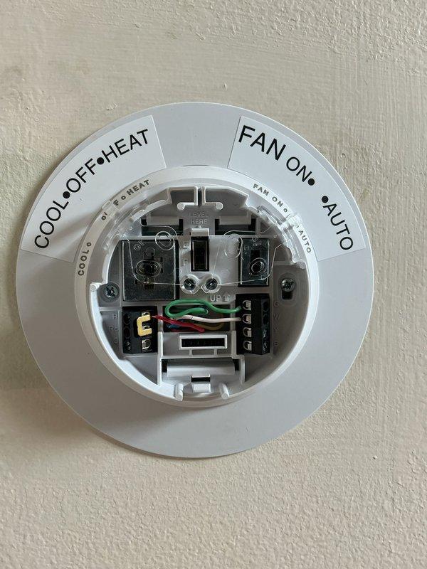 Returned to property to complete installation of Honeywell round mechanical thermostat. Verified proper wire terminations for heating, cooling, and fan control circuits. Tested system operation across all modes (Cool, Off, Heat, Fan On, Auto) to confirm proper functionality and communication with HVAC equipment.