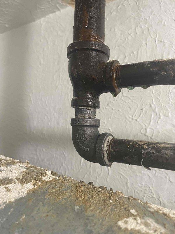 Responded to gas leak identified by utility company in vicinity of boiler piping. Performed visual inspection of black iron gas piping system, noting aged infrastructure with visible corrosion and surface deterioration at T-junction fittings and threaded connections. Documented condition of gas lines serving water heater and HVAC equipment in mechanical room. Recommended further pressure testing and leak detection procedures to isolate exact location of internal gas leak before system can be safely restored to operation.