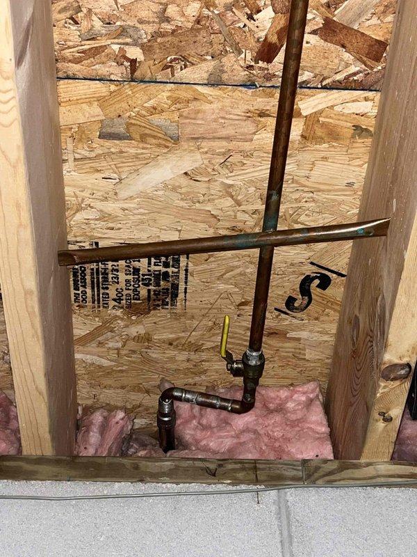 Installed two outdoor water spigots as part of a promotional service offering. Routed copper supply lines through interior wall framing, secured piping with appropriate hangers, and installed shut-off valves for seasonal maintenance. Mounted frost-free hose bibs on exterior white vinyl siding above brick foundation, ensuring proper drainage slope and weatherproof seal to prevent water intrusion.