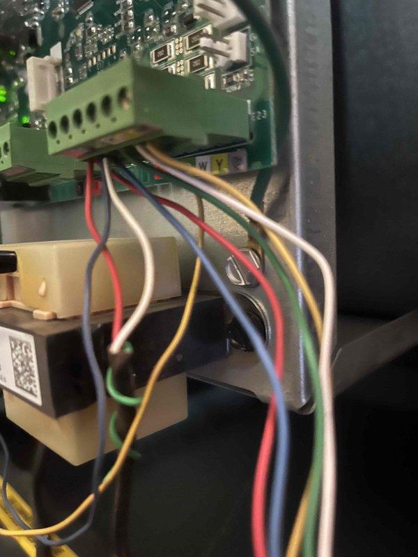 Conducted comprehensive assessment of existing 20-year-old residential air conditioning system that sustained hail damage to outdoor condensing unit. Documented current equipment condition through detailed photographic evidence, including interior control board components and exterior unit placement. System evaluated for insurance claim purposes with installation scheduled approximately 6 months from assessment date. Inspected control board assembly, wiring harness connections, terminal blocks, and electronic modules within unit housing. Exterior condensing unit examined showing horizontal fin configuration positioned on concrete pad against residence foundation with surrounding landscaping. Provided complete documentation and equipment specifications for HVAC replacement estimate to support insurance claim process.