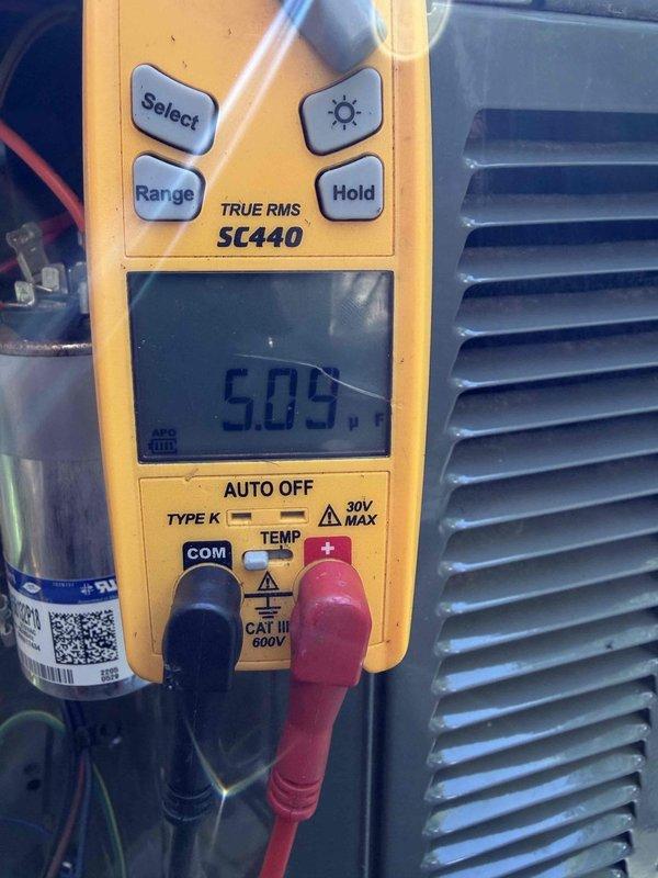Completed cooling maintenance on three systems for club member. Performed diagnostic testing using digital multimeter to measure voltage and amperage readings on HVAC components, including capacitor testing which showed normal operating parameters. One air handler unit continues to exhibit refrigerant leak despite previous service attempts. System was evaluated and documented with photos showing electrical measurements and component conditions. Service appointment has been rescheduled to address the ongoing leak issue and complete necessary repairs.
