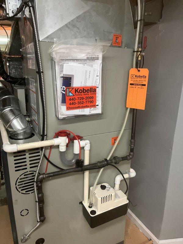 Completed full HVAC system installation including new furnace unit with proper venting and ductwork configuration. Installed electrical control panel with all required documentation and safety labels, established condensate pump and drainage system with PVC piping and shut-off valves, and verified system pressures at 8.3 units using calibrated digital gauges. All components properly mounted, labeled, and tested for operational functionality.