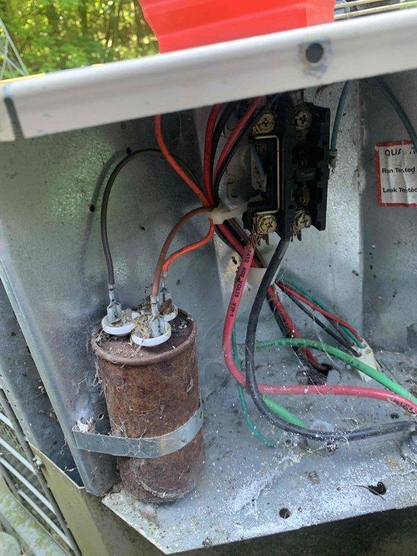 Performed comprehensive air conditioning tune-up on 12-year-old residential system. Upon inspection, discovered severely corroded dual run capacitor in outdoor condensing unit requiring immediate replacement due to extensive rust damage compromising electrical connections and component integrity. Replaced failed capacitor with new unit, verified proper microfarad readings with digital multimeter showing 37.47 µF, cleaned electrical compartment of debris, tested all electrical connections at terminal block, and confirmed system operational parameters within manufacturer specifications for safe seasonal operation.