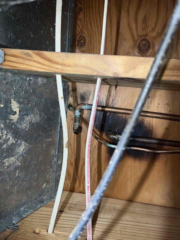 Installed refrigerator water line shutoff valve in 1977-built home, connecting existing copper refrigerator line to accommodate stainless steel refrigerator line connection. Accessed plumbing behind wall framing, installed shutoff valve on copper supply line, and configured connection point for stainless steel appliance line. Work completed successfully with proper valve placement for convenient future appliance access and maintenance.