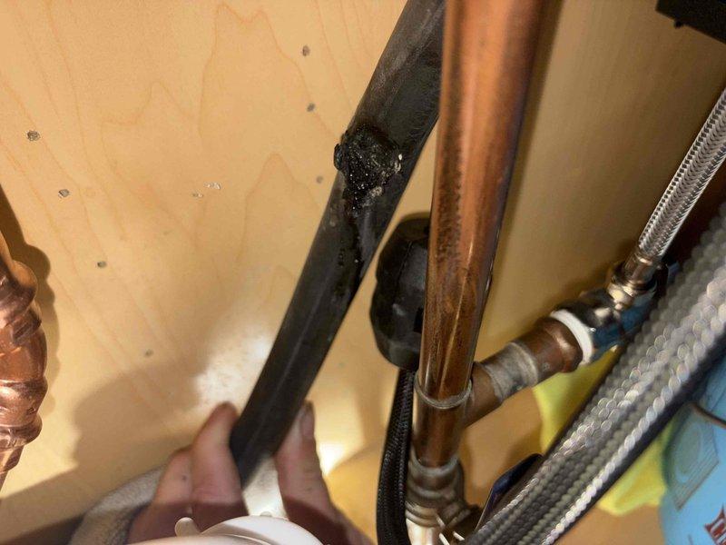 Responded to callback for leaking kitchen sink following previous repair. Upon inspection, discovered deteriorated pipe insulation and improper connection at drain assembly. Removed damaged insulation material, verified all compression fittings and hose clamps were properly secured, and tested system for leaks. All connections verified tight and operational with no active leaks detected upon completion.