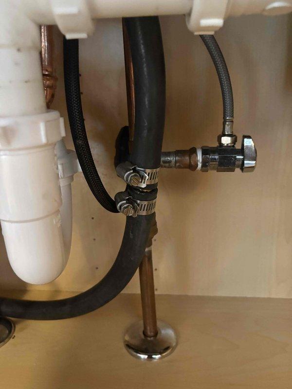 Responded to callback for leaking kitchen sink following previous repair. Upon inspection, discovered deteriorated pipe insulation and improper connection at drain assembly. Removed damaged insulation material, verified all compression fittings and hose clamps were properly secured, and tested system for leaks. All connections verified tight and operational with no active leaks detected upon completion.
