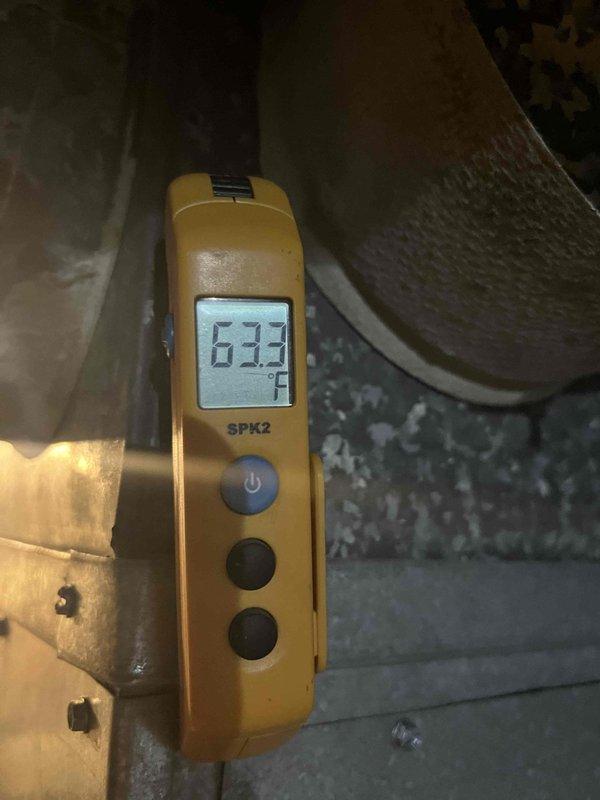 Responded to customer complaint of air conditioning system running continuously without adequate cooling. Performed diagnostic testing of the HVAC system, including temperature differential measurements at the outdoor condensing unit and supply air temperature readings at the air handler in the attic space. Measured supply air temperature of 63.2°F and recorded operational parameters including airflow and temperature split readings. Documented system performance with digital instrumentation showing temperature differentials and confirmed inadequate cooling capacity. System diagnostics indicated potential issues with refrigerant charge, airflow restriction, or component performance affecting overall cooling efficiency.