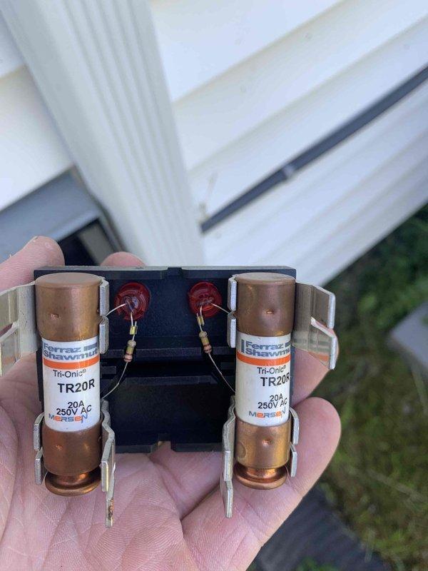 Completed final prepaid club maintenance visit on air handler system. Performed comprehensive inspection of electrical components including outdoor disconnect switch and fuse assembly. Verified proper operation of disconnect mechanism with ON/OFF functionality. Inspected and documented condition of dual 20-amp 250V AC Ferraz Shawmut Tri-Onic TR20R time-delay fuses with indicator lights, confirming secure mounting in fuse holder clips. Noted weathering and surface discoloration on exterior disconnect enclosure consistent with normal environmental exposure. All electrical safety devices functioning properly with no immediate service needs identified. System operational and ready for continued use.