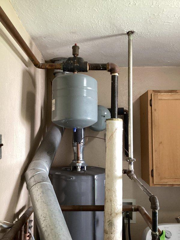Completed estimate for replacement of existing residential water heating system. Evaluated current setup including aged water heater with expansion tank, circulator pump, and associated copper piping showing oxidation and wear. Provided comprehensive replacement options for Navien tankless water heater system as referral recommendation, including removal of existing equipment and installation of new high-efficiency unit with updated venting, gas lines, and water connections to meet current code requirements.