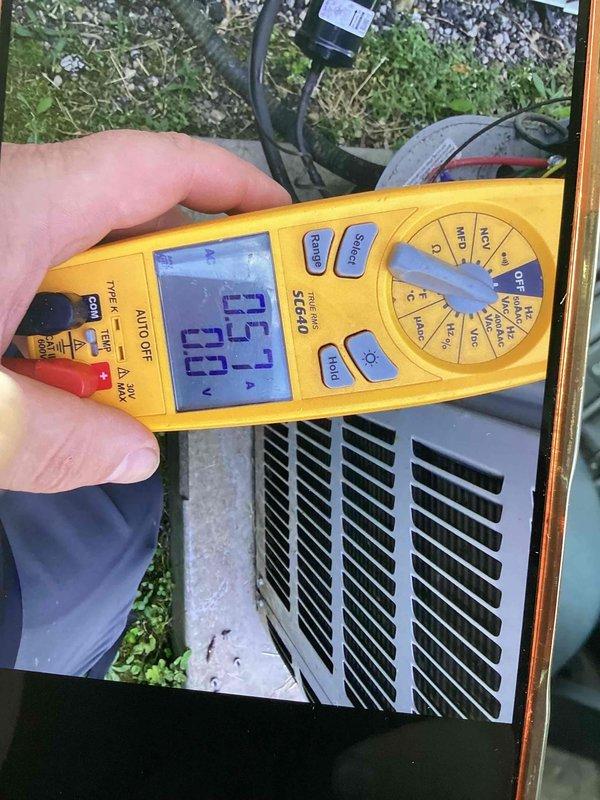 Responded to no cooling complaint following thermostat installation. Upon arrival, found outdoor condensing unit not operating. Performed diagnostic testing using digital multimeter and confirmed system had lost communication between new thermostat and air handler. Measured voltage at condenser unit showing 73.7V reading, indicating power supply issue from air handler. Troubleshot electrical connections and restored proper 24V control voltage to condensing unit. Verified system operation and confirmed air conditioning functionality restored.