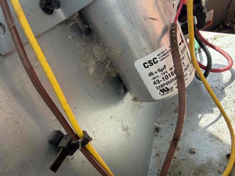 # HVAC Service Report

## Service Performed

Responded to no-cooling call on residential air conditioning system. Upon arrival, unit was completely non-operational with no power to outdoor condenser. Performed diagnostic testing with multimeter on electrical components. Found failed dual-run capacitor (45+1.5 μF, 440 VAC) with visible signs of deterioration and age-related wear. Capacitor showed no charge and tested open on both common and hermetic terminals. Removed defective capacitor and installed new OEM-equivalent dual-run capacitor with matching specifications. Verified all wire connections at contactor and capacitor terminals for tightness and proper polarity. Restored power to unit and confirmed compressor and condenser fan motor startup. System cycled properly with normal amp draw on both circuits. Tested operating pressures and temperatures—all within manufacturer specifications. Unit cooling effectively at time of departure.