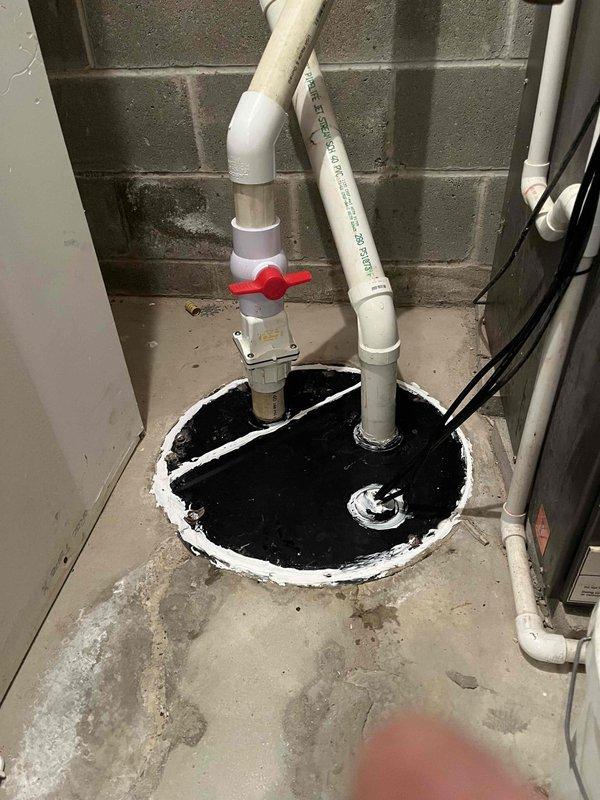 Responded to service call for non-operational waste/ejector pump system that had experienced a previous failure earlier in the month. Upon arrival, inspected the sump pit installation and associated discharge piping. Identified heavily corroded discharge pipes with significant oxidation and surface degradation affecting pump performance. Removed failed pump unit from pit and assessed system components including PVC discharge lines, ball valve assembly, and electrical connections. Replaced deteriorated piping connections and reinstalled functional pump assembly on protective sheeting to prevent floor contact issues. Verified proper pump operation, tested ball valve functionality, and ensured adequate water discharge through the system. System restored to full operational status.