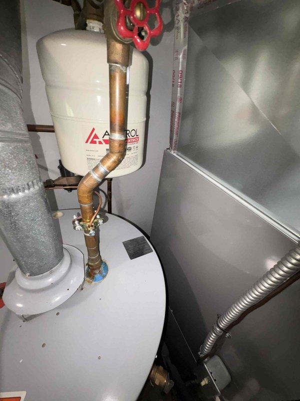Replaced residential water heater with new unit including installation of Amtrol expansion tank and proper copper piping connections. Connected all supply and discharge lines with appropriate shut-off valves and safety devices. Verified proper operation of new water heater system and ensured all connections were secure and leak-free.