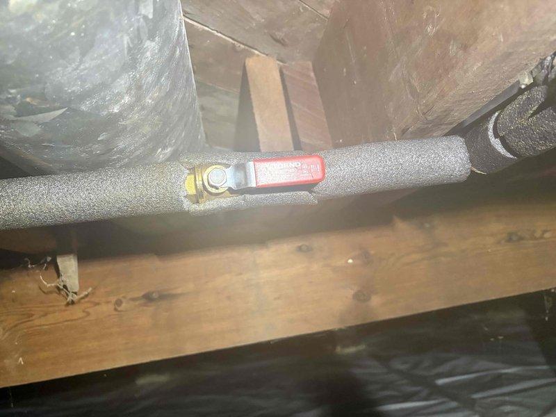Responded to emergency call for broken pipe located under the residence in crawlspace area. Upon arrival, discovered compromised copper piping with failed shutoff valve, preventing water isolation to the affected line. Accessed confined crawlspace through existing entry point and performed thorough inspection of accessible plumbing infrastructure. Located primary leak at copper pipe joint with compression fitting showing signs of failure and corrosion. Existing shutoff valve mechanism was inoperable due to deteriorated internal components, requiring immediate replacement to establish water control capability.

Shut off main water supply to residence to prevent further water damage and facilitate safe repair conditions. Removed failed shutoff valve assembly and prepared copper pipe ends for new installation. Installed new quarter-turn ball valve with red handle for easy identification and operation, ensuring proper compression fittings and leak-free connections. Tested valve operation m