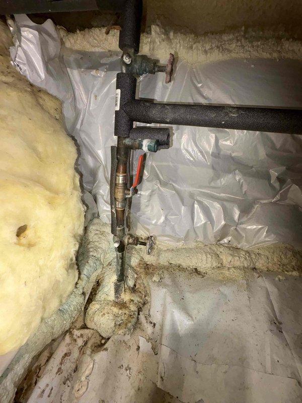 Responded to emergency call for broken pipe located under the residence in crawlspace area. Upon arrival, discovered compromised copper piping with failed shutoff valve, preventing water isolation to the affected line. Accessed confined crawlspace through existing entry point and performed thorough inspection of accessible plumbing infrastructure. Located primary leak at copper pipe joint with compression fitting showing signs of failure and corrosion. Existing shutoff valve mechanism was inoperable due to deteriorated internal components, requiring immediate replacement to establish water control capability.

Shut off main water supply to residence to prevent further water damage and facilitate safe repair conditions. Removed failed shutoff valve assembly and prepared copper pipe ends for new installation. Installed new quarter-turn ball valve with red handle for easy identification and operation, ensuring proper compression fittings and leak-free connections. Tested valve operation m