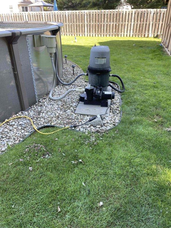 # Plumbing Estimate - Gas Line Installation for Pool Heater

Conducted site assessment for new gas line installation to service a brand new pool heater at a residential property. Currently no existing gas line runs to the heater location in the backyard pool equipment area. The pool circulation system includes a cylindrical filter cartridge housing mounted on a pump motor unit, positioned on a concrete pad within a gravel bed adjacent to a spa unit. 

Evaluated the routing requirements from the main gas supply to the pool heater location, accounting for the distance across the lawn area and proximity to existing pool equipment. Assessed the installation site conditions including the landscaped areas, gravel bed surrounding the equipment pad, and property layout to determine optimal pipe routing that minimizes disruption to existing landscaping while maintaining code compliance.

Documented the current equipment setup with the pump and filtration system to ensure proper clearances and s