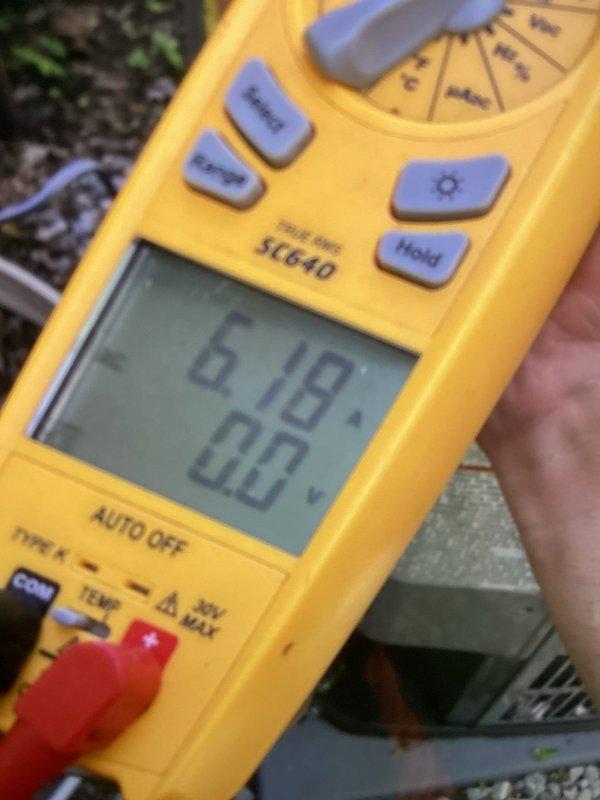 Performed cooling maintenance and system diagnostics on dual-zone HVAC system experiencing temperature imbalance between floors. Utilized digital multimeter to measure and verify electrical readings and system performance parameters, documenting findings with diagnostic measurements showing 0.62/0.5 readings and 0.18/0.0 readings across different test points. Inspected outdoor unit components and refrigerant lines to identify potential airflow restrictions or mechanical issues causing inadequate cooling distribution to lower level while upper level overheats.