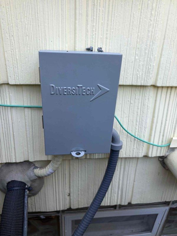 Completed cooling maintenance club visit on air handler system. Performed routine inspection and testing of electrical components, verified proper voltage readings at disconnect box measuring 397.0 microamps, and documented equipment condition through photographs. All systems operating within normal parameters.