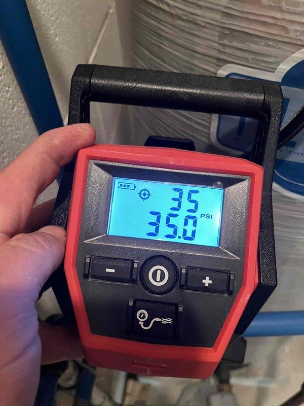 Responded to customer concerns regarding reduced water pressure during simultaneous fixture use and clicking sounds from the pressure tank. Performed diagnostic testing of the well water system, including pressure gauge readings which confirmed system pressure at 35 PSI. Inspected the pressure tank installation, copper piping connections, pressure relief valves, and associated plumbing components for proper operation and potential issues affecting water pressure delivery throughout the residence.