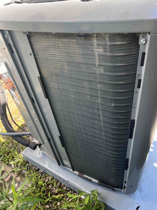 Completed cooling maintenance visit for air handler system. Inspected outdoor HVAC unit and found significantly clogged air filter with heavy dust and debris accumulation. Removed side panel to access condenser coil, which exhibited dirt buildup and debris between fins requiring attention. Documented equipment condition showing visible discoloration on coil surfaces and restricted airflow due to contamination. Performed standard maintenance procedures including filter inspection and coil assessment to ensure proper system operation and efficiency.