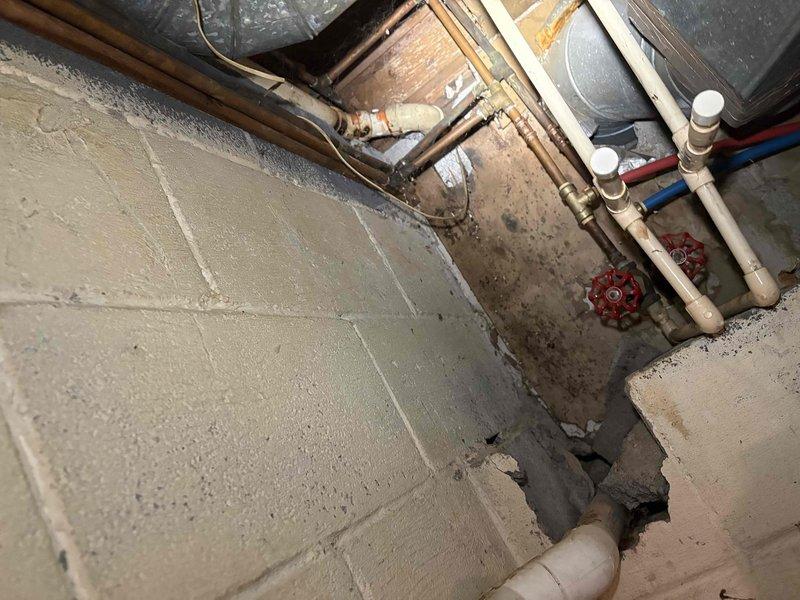 Responded to service call for clogged kitchen sink and bathroom sink. Upon arrival, accessed plumbing system through basement utility area to locate and address drainage obstruction. Inspected exposed drain lines, PVC piping, and water supply lines in crawl space and basement areas. Successfully cleared blockages in both affected drains, restoring proper water flow and drainage function to kitchen and bathroom sinks. Verified all connections were secure and tested drainage system to ensure complete resolution of clogging issues.