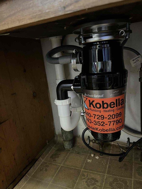 Responded to emergency call for garbage disposal that had detached from sink mounting assembly. Reinstalled and secured Kobella Perfect Grind garbage disposal unit to sink basin, ensuring proper mounting bracket alignment and watertight seal. Verified all PVC drain connections and P-trap configuration for proper fit and function. Additionally, removed and replaced existing toilet with new two-piece unit, including wax ring installation and water supply line connection. Tested both fixtures for proper operation and confirmed no leaks present upon completion.