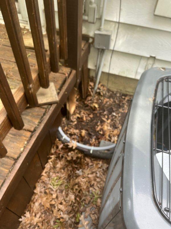 Completed follow-up repair in tight crawl space conditions, requiring two hours to access and seal thermostat wire penetration. Installed 1/2-inch seal tight conduit to properly protect and secure thermostat wiring from outdoor HVAC unit to interior mechanical room. Work involved navigating confined space between building exterior and deck structure where condensing unit is located. Ensured all thermostat wire connections are now properly protected from environmental exposure and mechanical damage per code requirements.