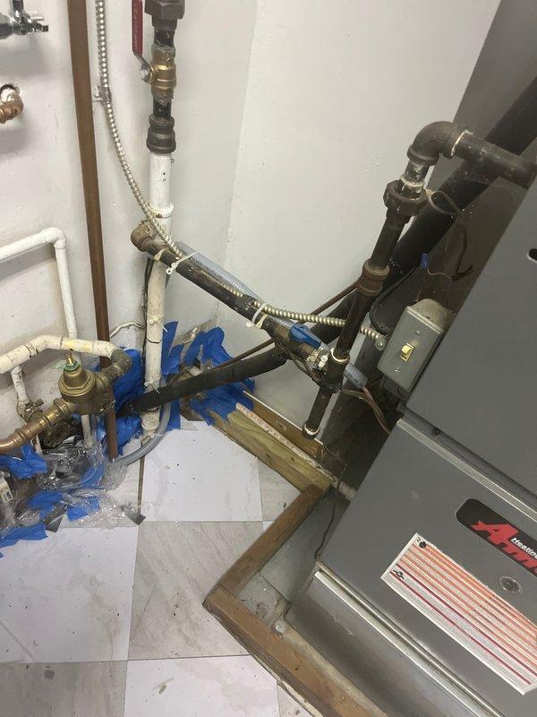 Completed follow-up repair in tight crawl space conditions, requiring two hours to access and seal thermostat wire penetration. Installed 1/2-inch seal tight conduit to properly protect and secure thermostat wiring from outdoor HVAC unit to interior mechanical room. Work involved navigating confined space between building exterior and deck structure where condensing unit is located. Ensured all thermostat wire connections are now properly protected from environmental exposure and mechanical damage per code requirements.