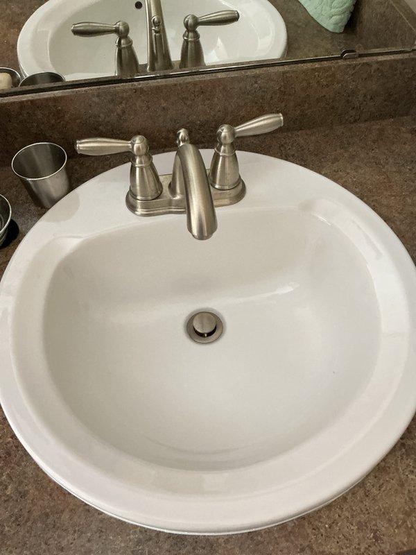 Completed routine plumbing maintenance inspection as part of recurring membership visit. Performed comprehensive evaluation of bathroom fixtures including sink faucet assembly with dual lever handles, drain stoppers, and jetted bathtub system with multiple jet ports and chrome fixtures. All plumbing components were inspected for proper operation, leaks, and overall functionality, with photographic documentation captured for service records.