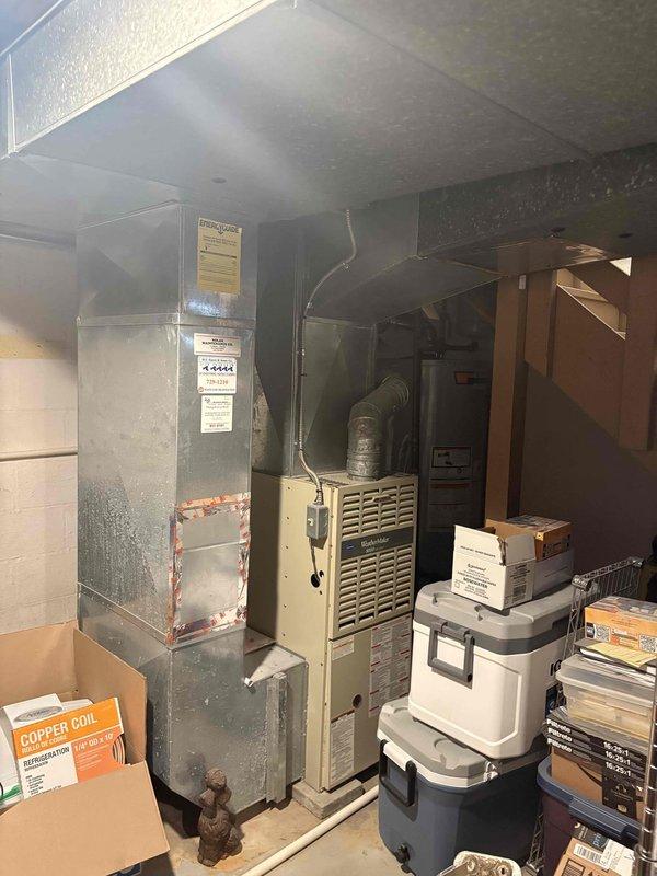 Provided comprehensive estimate for air conditioning replacement on residential property addition. Evaluated existing 13-year-old R22 system currently located in basement mechanical room, including assessment of air handler unit and associated ductwork infrastructure. Presented options comparing reinstallation of existing equipment versus new system installation. Documented current HVAC configuration including basement-mounted air handler with metal ductwork connections and exterior mini-split condenser unit mounted on foundation with proper electrical disconnect and condensate drainage. Customer reviewing replacement options for aging R22 refrigerant system to determine most cost-effective solution for climate control needs in building addition.