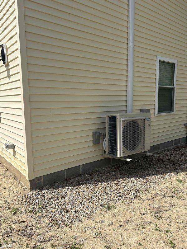 Provided comprehensive estimate for air conditioning replacement on residential property addition. Evaluated existing 13-year-old R22 system currently located in basement mechanical room, including assessment of air handler unit and associated ductwork infrastructure. Presented options comparing reinstallation of existing equipment versus new system installation. Documented current HVAC configuration including basement-mounted air handler with metal ductwork connections and exterior mini-split condenser unit mounted on foundation with proper electrical disconnect and condensate drainage. Customer reviewing replacement options for aging R22 refrigerant system to determine most cost-effective solution for climate control needs in building addition.