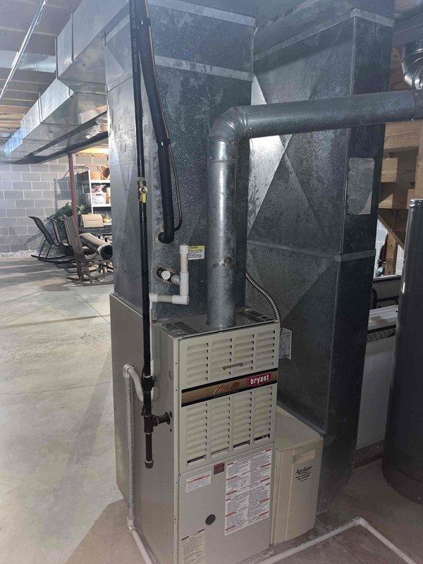 Responded to no-cooling call on residential air conditioning system. Upon arrival, performed diagnostic evaluation of Bryant HVAC system located in basement mechanical room. Inspected furnace unit, air handler assembly, and associated ductwork for proper operation and potential failure points. Documented equipment condition with photographic evidence showing system configuration and components. Discussed repair options with homeowner given budget constraints and deferred replacement timeline. System evaluated and customer advised of findings and recommendations for maintaining operation until future replacement can be scheduled.
