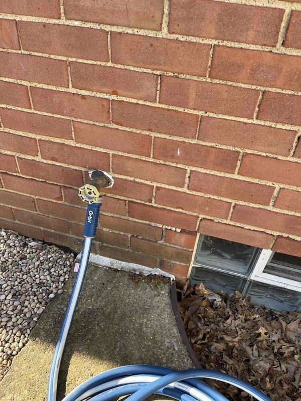 Upgraded outdoor spigot fixture to dual-handle configuration with both hot and cold water supply lines. Installed brass dual-handle valve assembly on exterior wall, connecting to existing plumbing infrastructure to provide temperature-controlled water access for outdoor use.