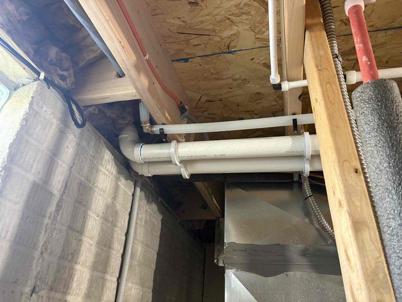 # Deduct Meter Installation

Completed installation of a deduct meter in the basement utility area. Consulted with homeowner regarding the deduct meter process and requirements. Installed metering equipment with proper PVC piping connections integrated into the existing plumbing system. Mounted meter assembly securely to the wall structure using appropriate brackets and straps. Ensured all connections were properly sealed and tested for functionality. Verified meter placement complied with code requirements for accessibility and proper operation. Documented installation with photographs showing the completed meter installation and associated piping configuration in the unfinished basement space.