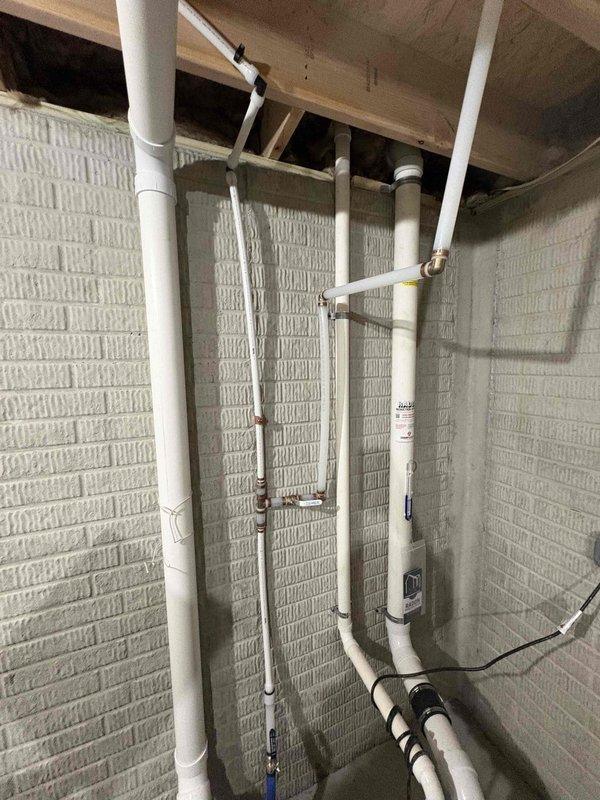 # Deduct Meter Installation

Completed installation of a deduct meter in the basement utility area. Consulted with homeowner regarding the deduct meter process and requirements. Installed metering equipment with proper PVC piping connections integrated into the existing plumbing system. Mounted meter assembly securely to the wall structure using appropriate brackets and straps. Ensured all connections were properly sealed and tested for functionality. Verified meter placement complied with code requirements for accessibility and proper operation. Documented installation with photographs showing the completed meter installation and associated piping configuration in the unfinished basement space.