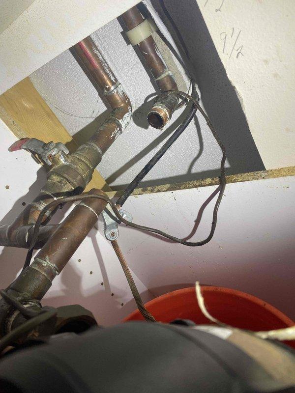 Returned to property to complete installation of new shower cartridge and pressure reducing valve (PRV) as previously sold. Accessed shower valve assembly through existing wall opening, removed old worn cartridge showing mineral deposits and corrosion, and installed replacement cartridge. Inspected PRV and associated plumbing connections in water heater compartment, verified proper operation of gas valve assembly and copper piping connections. All components tested and functioning properly upon completion.