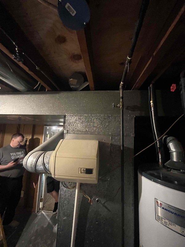 Conducted comprehensive evaluation of existing HVAC system with 1970 AC compressor requiring replacement. Assessed basement-mounted equipment including humidifier unit, ductwork configuration, and gas furnace which was confirmed to be in proper working condition. Documented exterior utility connections and pressure regulation equipment for system specifications. Provided detailed replacement estimate for aging air conditioning compressor unit while verifying all associated mechanical systems and infrastructure to ensure compatibility with new equipment installation.