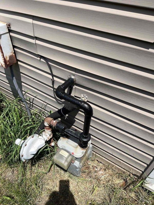 Conducted comprehensive evaluation of existing HVAC system with 1970 AC compressor requiring replacement. Assessed basement-mounted equipment including humidifier unit, ductwork configuration, and gas furnace which was confirmed to be in proper working condition. Documented exterior utility connections and pressure regulation equipment for system specifications. Provided detailed replacement estimate for aging air conditioning compressor unit while verifying all associated mechanical systems and infrastructure to ensure compatibility with new equipment installation.