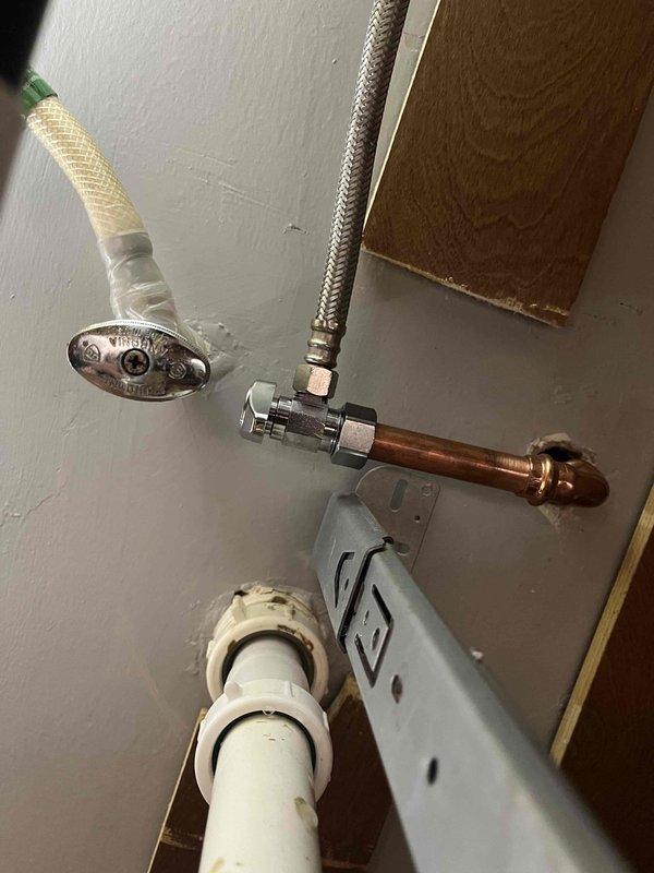 Responded to emergency call for leaking water shutoff valve in seventy-year-old residential property. Assessed existing plumbing configuration including aged copper piping, chrome shut-off valves, flexible braided supply lines, and PVC drainage components. Replaced faulty shutoff valve to eliminate active water leak and restore proper system operation, ensuring all connections were secure and tested for integrity before completing service.