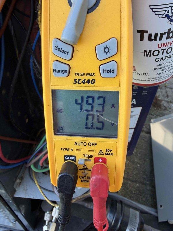Completed cooling maintenance club visit on air handler system. Performed comprehensive electrical diagnostics using digital multimeter, recording voltage readings of 232V and amperage draw of 49.3A to verify proper system operation and motor performance. Inspected and tested motor capacitor to ensure adequate charge and functionality. Evaluated all electrical connections, wiring, and components for secure installation and proper operation. Documented equipment conditions with photographs for maintenance records. System operating within normal parameters upon completion of maintenance visit.
