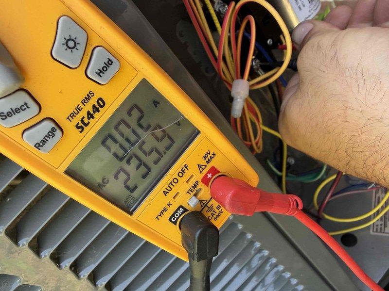 Completed prepaid cooling maintenance visit. Performed electrical diagnostics using digital multimeter, recording voltage and amperage readings on HVAC system components. Documented service findings on company tag and left on-site for customer records.