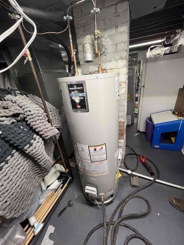 Responded to service call for 40-gallon natural gas atmospheric vent water heater experiencing inadequate hot water recovery and insufficient capacity for single shower use. Unit manufactured approximately 2017, installed in basement mechanical room with standard copper supply lines and proper expansion tank configuration. 

Performed diagnostic evaluation of water heater performance and thermal efficiency. Inspected burner assembly, thermocouple, gas control valve, and temperature/pressure relief valve for proper operation. Verified gas supply pressure and combustion air availability for atmospheric venting system. Assessed flue venting integrity and draft performance. Examined sediment accumulation in tank bottom through drain valve inspection. Evaluated dip tube condition and potential deterioration affecting cold water delivery to burner area. Tested thermostat calibration and temperature settings against actual water delivery temperatures. Inspected anode rod condition as factor i