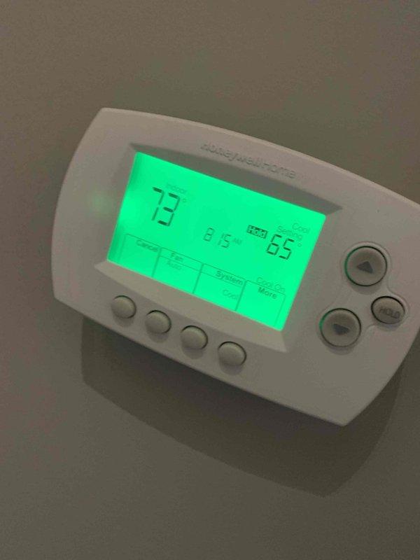 Responded to customer concern regarding insufficient heating. Performed system diagnostic and refrigerant charge verification on air conditioning unit. Thermostat displaying 73°F ambient temperature with setpoint at 65°F, indicating system operating within normal parameters at time of inspection.